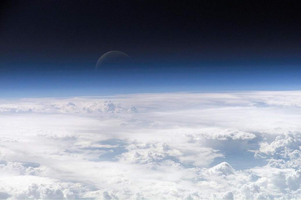 Earth’s atmosphere as a thin glowing film on the limb.