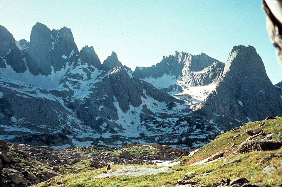 A steep-walled cirque bowl holding a tarn in glaciated mountains.