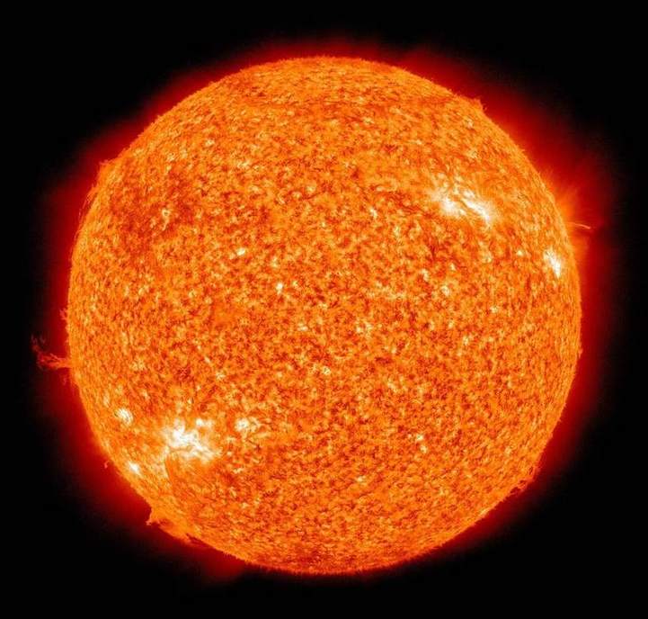 The Sun as a disk; Earth is a speck at true scale.