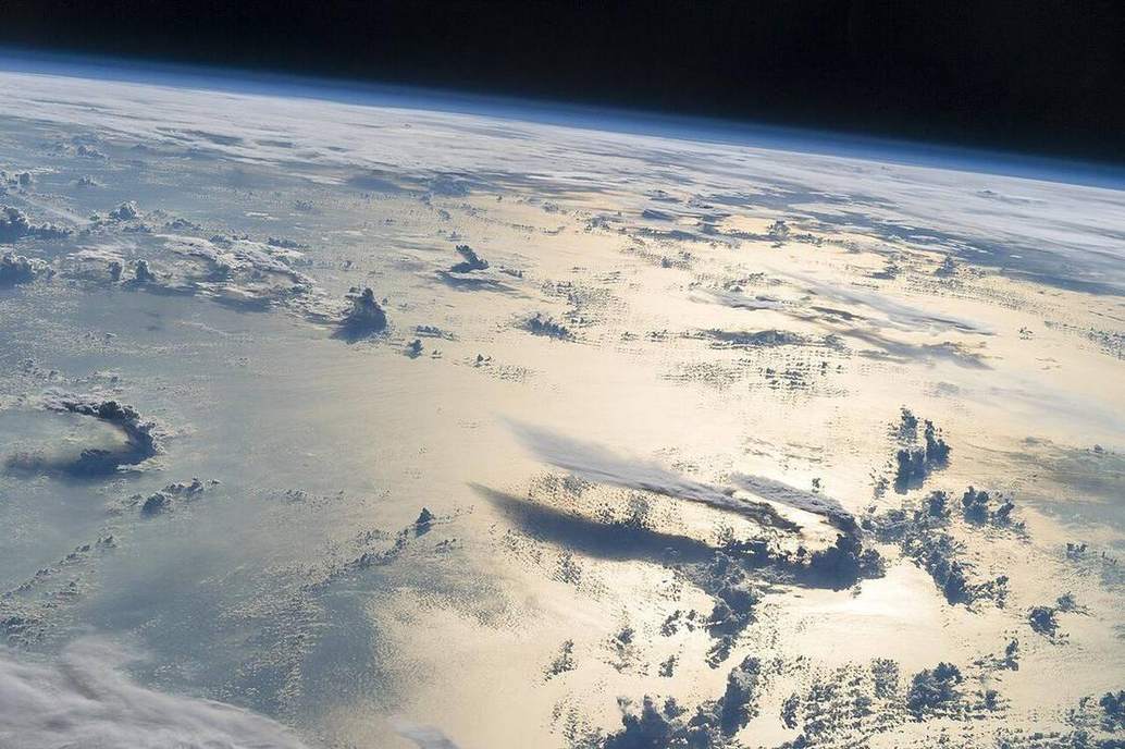 Weather as a thin cloud layer from orbit.